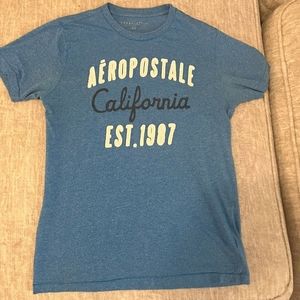 Blue t shirt with brand name logo that stands out